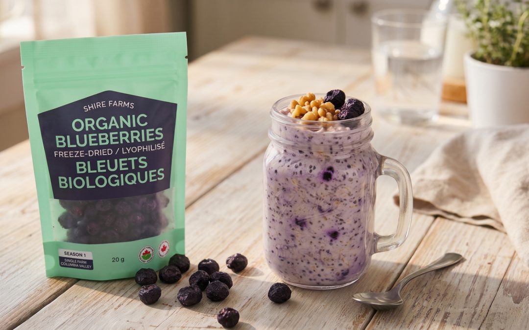 A jar of blueberry overnight oats topped with walnuts and freeze-dried blueberries beside a pouch of Shire Farms organic blueberries on a wooden table