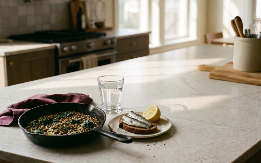 Cast iron skillet of lentils and spinach with sardines on rye toast and lemon, iron-rich foods for low iron and anemia